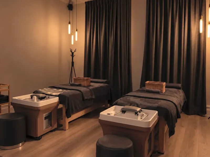 A treatment room at Hikari with head spa beds and basins in low, warm light