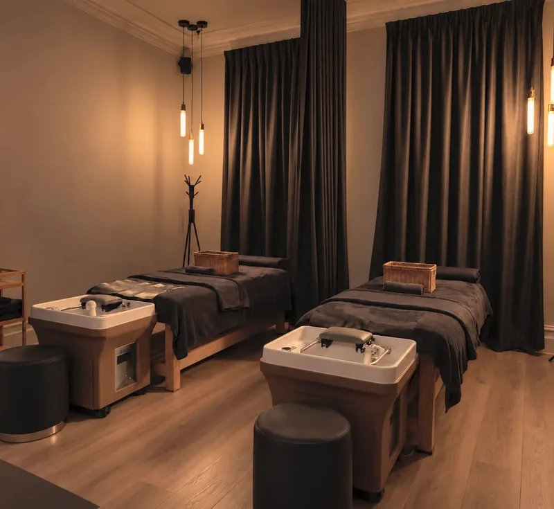 A private treatment room at Hikari with two head spa beds and basins in low, warm light